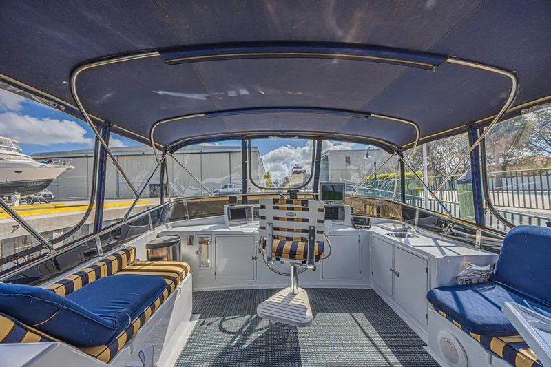 Slide: The Image of 1996 Jefferson 52 Rivanna Cockpit MY interior with striped seating and navigation equipment. - 15