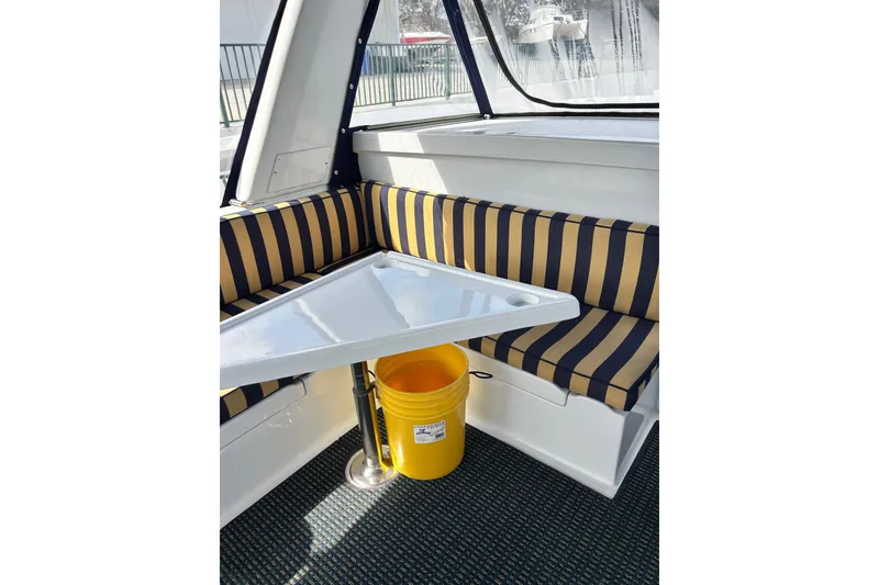 Slide: The Image of 1996 Jefferson 52 Rivanna Cockpit MY interior with striped seating and triangular table. - 17