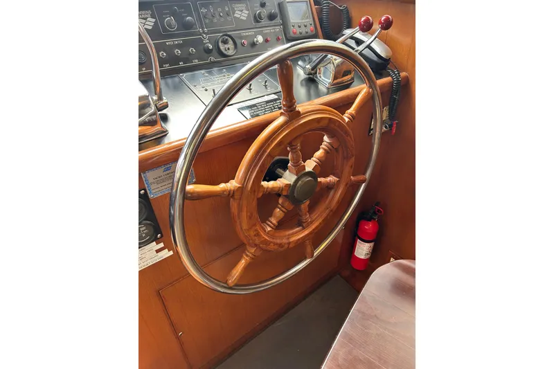 Slide: The Image of Wooden steering wheel and control panel of a 1996 Jefferson 52 Rivanna Cockpit MY yacht. - 30