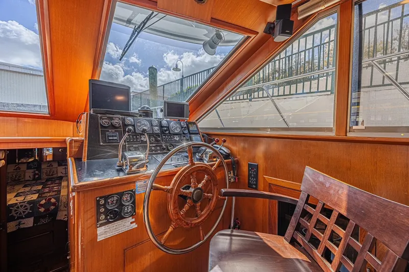 Slide: The Image of 1996 Jefferson 52 Rivanna Cockpit MY helm with wooden wheel and navigation instruments. - 31