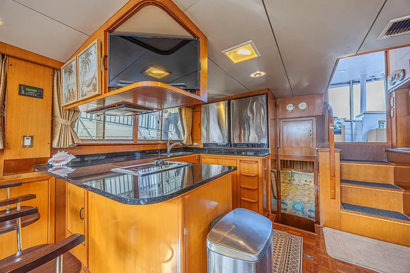 Slide: The Image of Luxurious 1996 Jefferson 52 Rivanna yacht interior with modern kitchen and elegant wood finishes. - 33