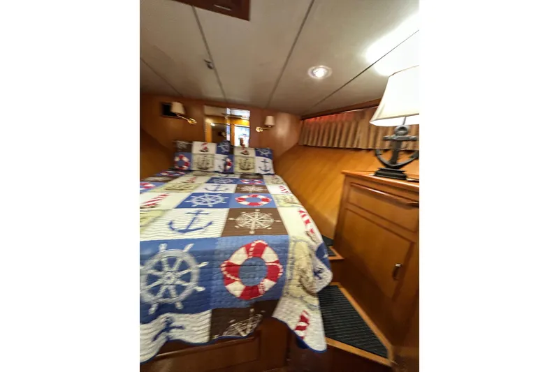 Slide: The Image of Cozy cabin interior of 1996 Jefferson 52 Rivanna Cockpit MY with nautical-themed bedding. - 40