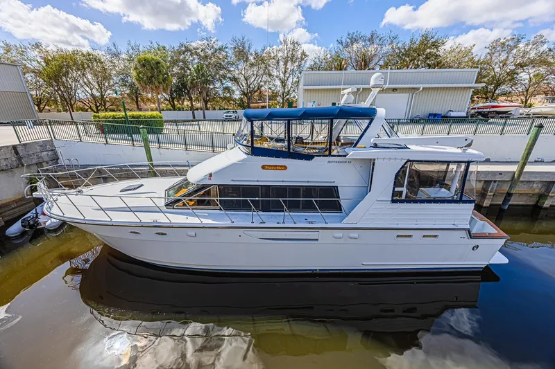 Slide: The Image of 1996 Jefferson 52 Rivanna Cockpit MY yacht docked, featuring sleek design and spacious deck. - 5