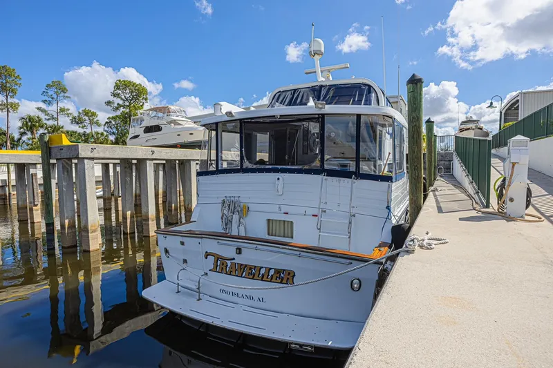 Slide: The Image of 1996 Jefferson 52 Rivanna Cockpit MY docked at marina under blue sky. - 6