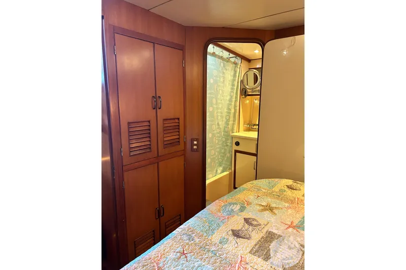 Slide: The Image of Interior of 1996 Jefferson 52 Rivanna Cockpit MY with wooden cabinets and bathroom view. - 64