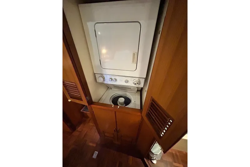 Slide: The Image of Laundry area inside 1996 Jefferson 52 Rivanna Cockpit MY yacht with wood cabinetry. - 65