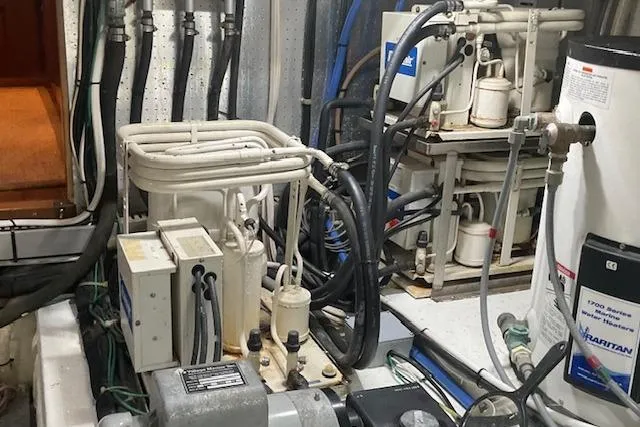 Slide: The Image of Engine room of a 1996 Jefferson 52 Rivanna Cockpit MY with various mechanical components. - 70