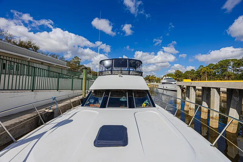 Slide: The Image of 1996 Jefferson 52 Rivanna Cockpit MY yacht docked under a vibrant blue sky. - 76