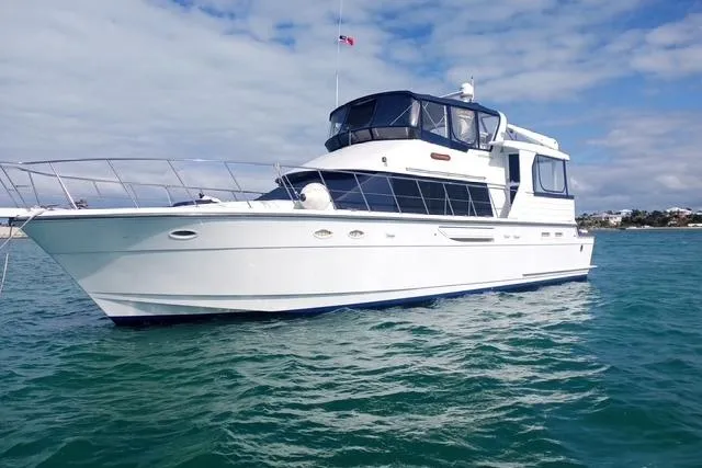 Slide: The Image of 1996 Jefferson 52 Rivanna Cockpit MY yacht on open water under a partly cloudy sky. - 1
