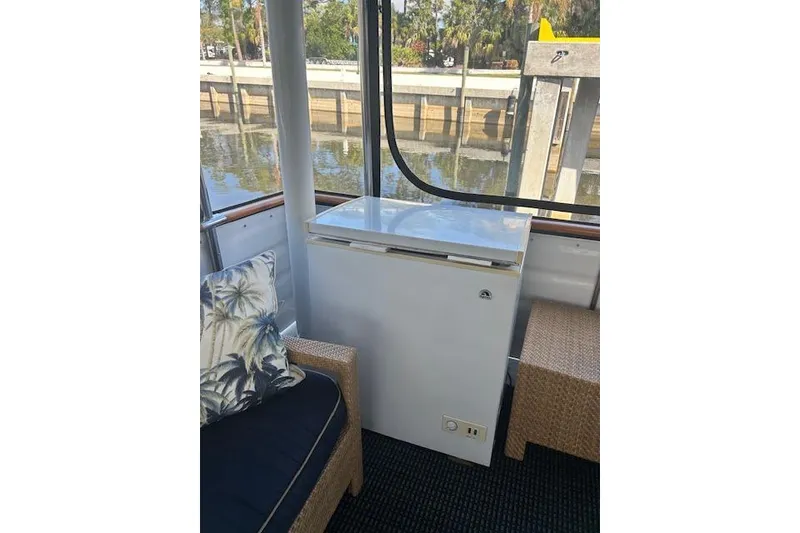 Slide: The Image of Interior of 1996 Jefferson 52 Rivanna Cockpit MY with a white chest freezer. - 10