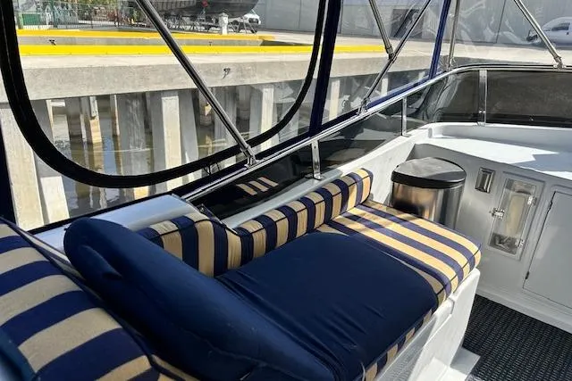 Slide: The Image of 1996 Jefferson 52 Rivanna Cockpit MY with striped seating and enclosed cockpit view. - 14