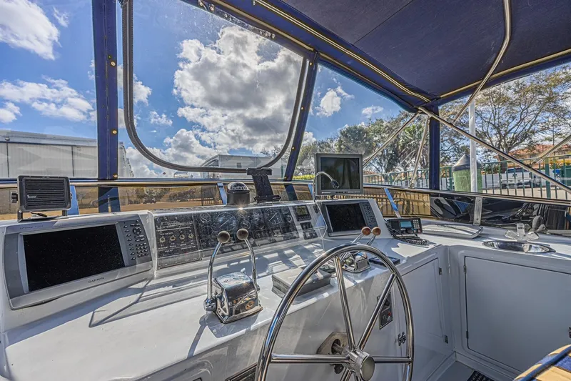 Slide: The Image of Cockpit of 1996 Jefferson 52 Rivanna yacht with steering wheel and navigation equipment. - 19