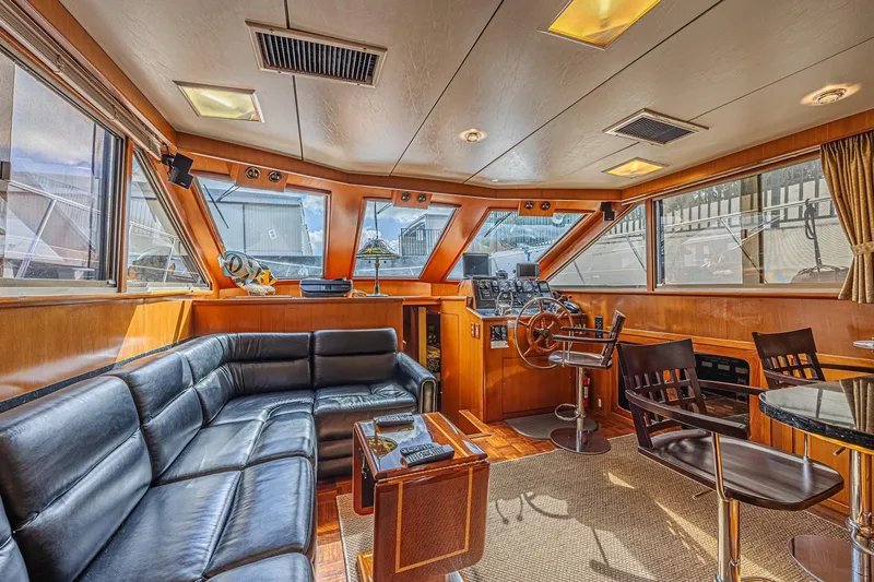 Slide: The Image of Luxurious interior of a 1996 Jefferson 52 Rivanna Cockpit MY yacht with leather seating. - 24
