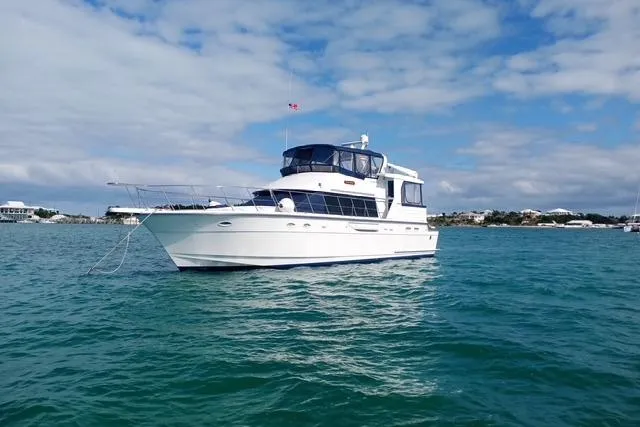 Slide: The Image of 1996 Jefferson 52 Rivanna Cockpit MY yacht on calm blue waters under a partly cloudy sky. - 3