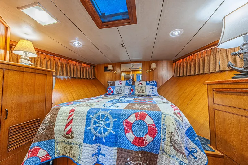 Slide: The Image of Cozy cabin interior of 1996 Jefferson 52 Rivanna Cockpit MY with nautical-themed bedding. - 36