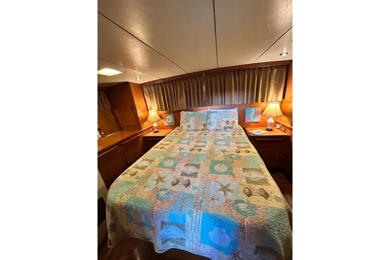 Slide: The Image of Cozy bedroom in 1996 Jefferson 52 Rivanna Cockpit MY yacht with nautical-themed bedding. - 56