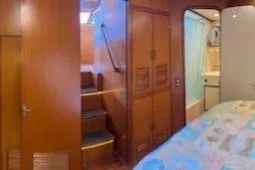 Slide: The Image of Interior of 1996 Jefferson 52 Rivanna Cockpit MY yacht with wood paneling and cozy bedroom. - 57