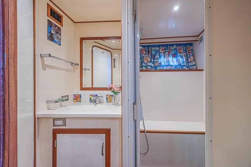 Slide: The Image of Bathroom interior of 1996 Jefferson 52 Rivanna Cockpit MY yacht, featuring nautical-themed decor. - 66