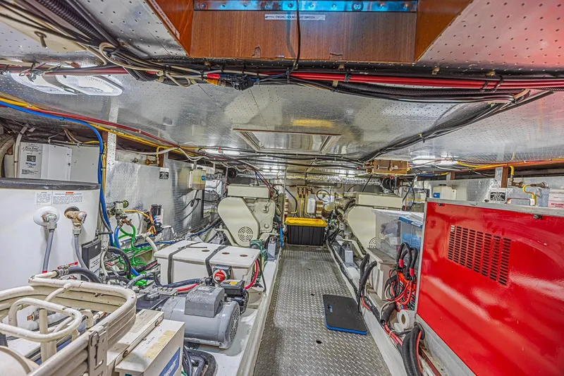 Slide: The Image of Engine room of a 1996 Jefferson 52 Rivanna Cockpit MY yacht, showcasing machinery and wiring. - 68