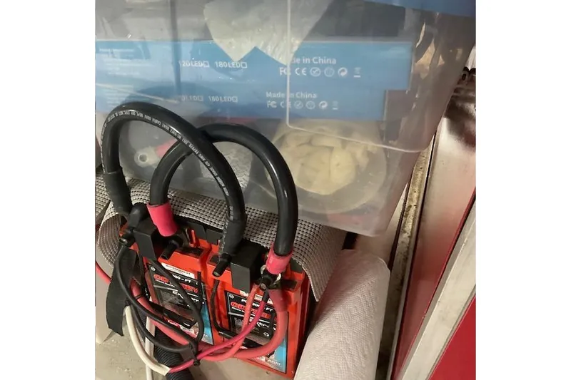 Slide: The Image of Battery charger with cables in a storage area on a 1996 Jefferson 52 Rivanna Cockpit MY. - 71