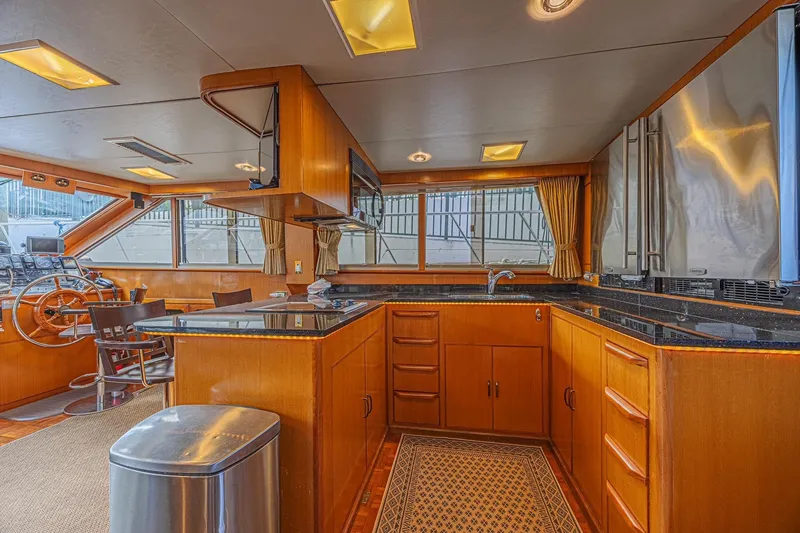 Slide: The Image of Luxurious interior of 1996 Jefferson 52 Rivanna Cockpit MY yacht with modern kitchen and helm. - 28