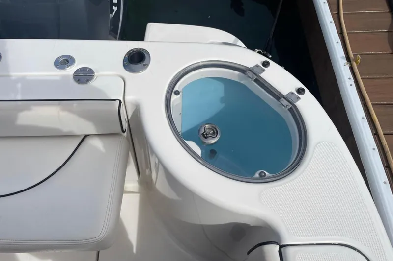 Slide: The Image of 2007 Robalo R305 Walkaround boat with livewell and seating area. - 10