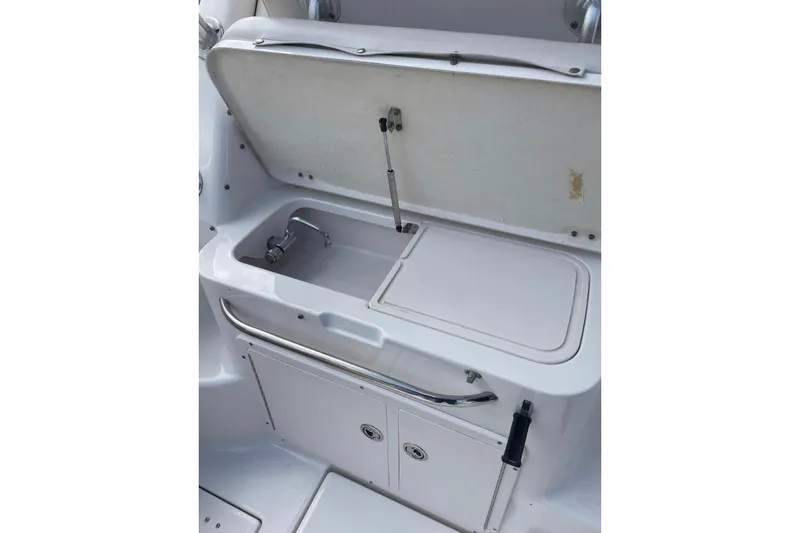 Slide: The Image of 2007 Robalo R305 Walkaround boat sink and storage area. - 11