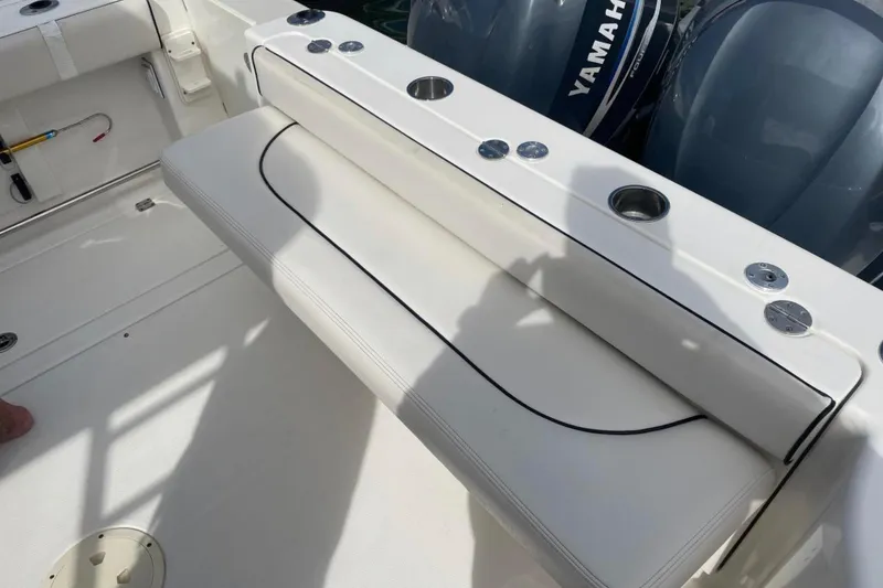 Slide: The Image of 2007 Robalo R305 Walkaround boat interior with seating and Yamaha engines. - 12