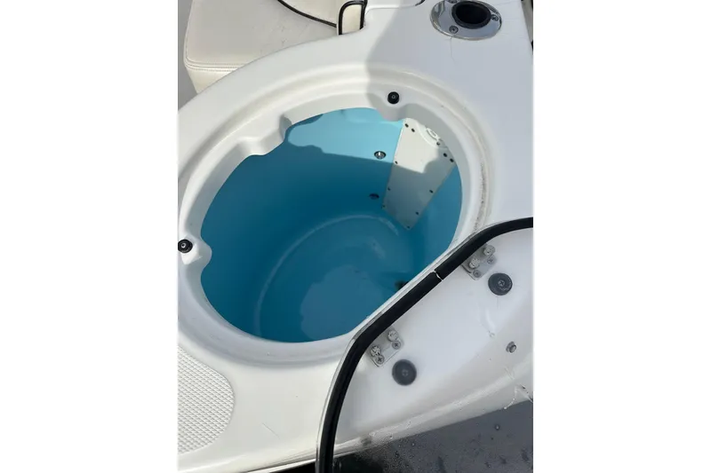 Slide: The Image of Livewell on 2007 Robalo R305 Walkaround boat, featuring a clean, blue interior. - 13