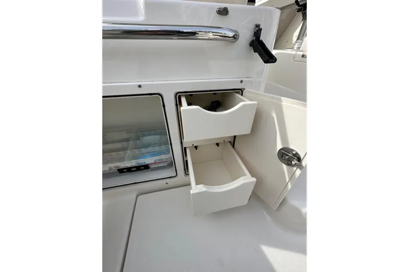 Slide: The Image of 2007 Robalo R305 Walkaround boat storage drawers and compartment detail. - 18
