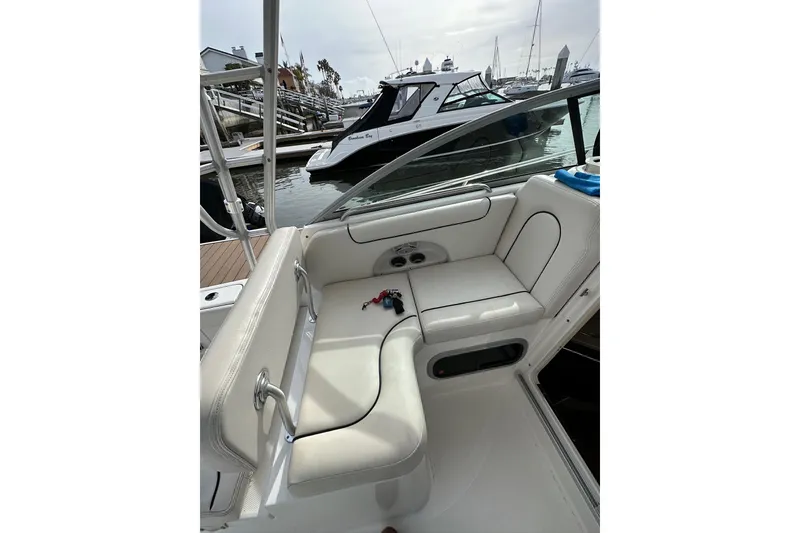 Slide: The Image of 2007 Robalo R305 Walkaround boat interior with white seating at marina. - 20