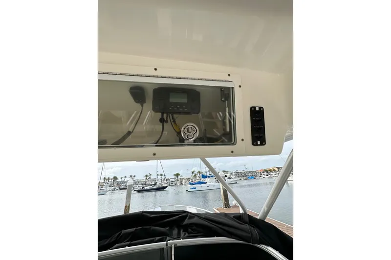 Slide: The Image of 2007 Robalo R305 Walkaround boat console with marina view in background. - 22