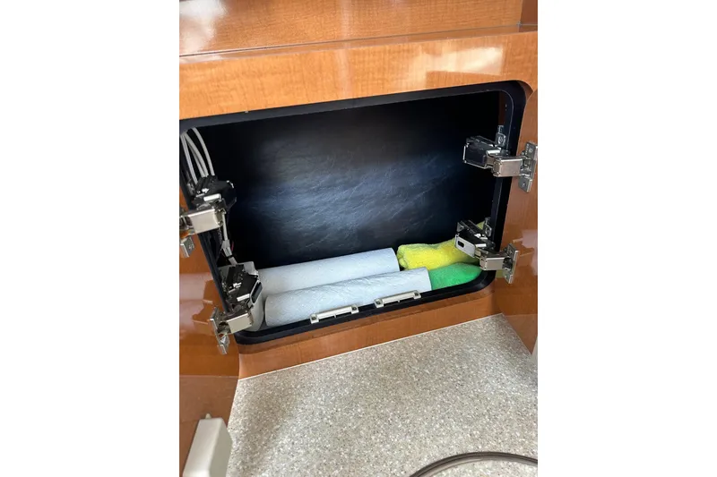 Slide: The Image of 2007 Robalo R305 Walkaround cabinet with paper towels and cleaning supplies. - 30