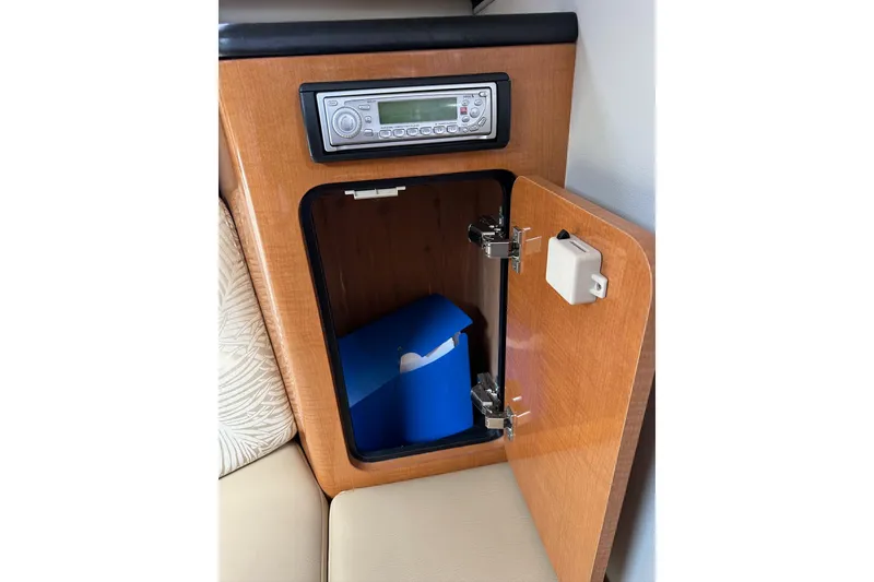 Slide: The Image of 2007 Robalo R305 Walkaround cabin with stereo and open storage compartment. - 32