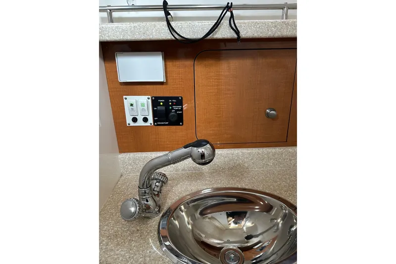 Slide: The Image of 2007 Robalo R305 Walkaround boat interior with sink, faucet, and control panel. - 34