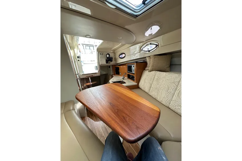 Slide: The Image of 2007 Robalo R305 Walkaround cabin interior with wooden table and seating area. - 38