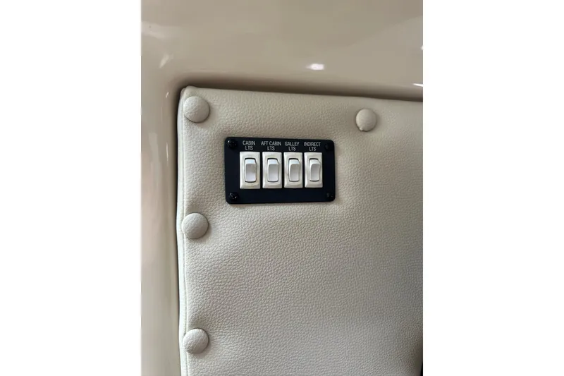 Slide: The Image of 2007 Robalo R305 Walkaround light switches on beige interior panel. - 40