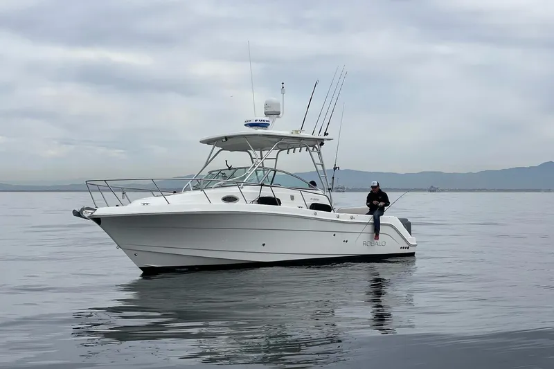 Slide: The Image of 2007 Robalo R305 Walkaround boat on calm water with fishing gear. - 5