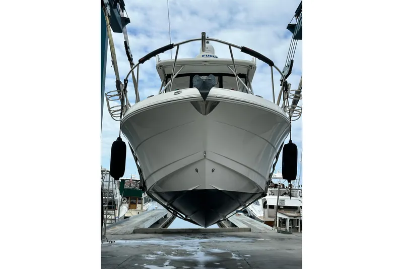 Slide: The Image of 2007 Robalo R305 Walkaround boat on lift at marina, front view. - 6