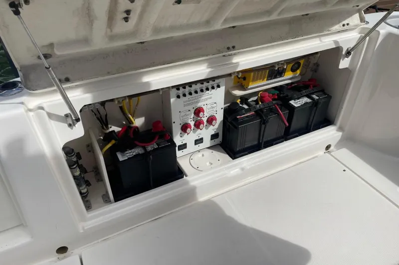 Slide: The Image of 2007 Robalo R305 Walkaround boat battery compartment with wiring and control panel. - 8