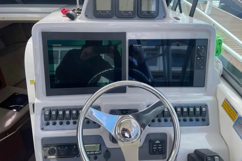 Slide: The Image of 2007 Robalo R305 Walkaround helm with dual screens and steering wheel. - 9
