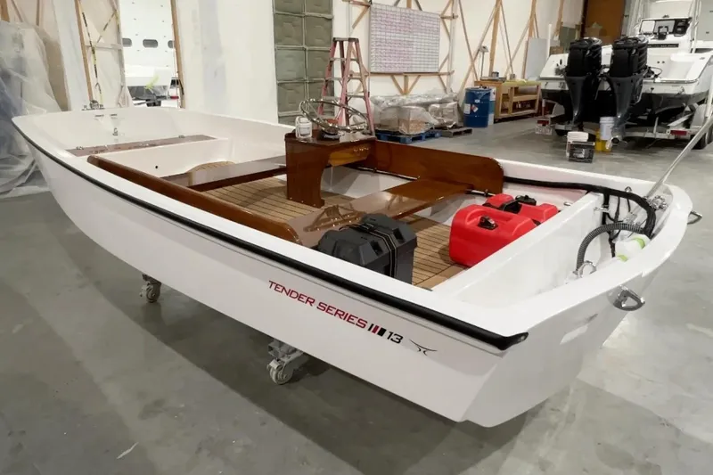 Slide: The Image of Manufacturer Provided Image: 2026 Metan Sport 13 boat in a workshop, featuring a sleek white design. - 2