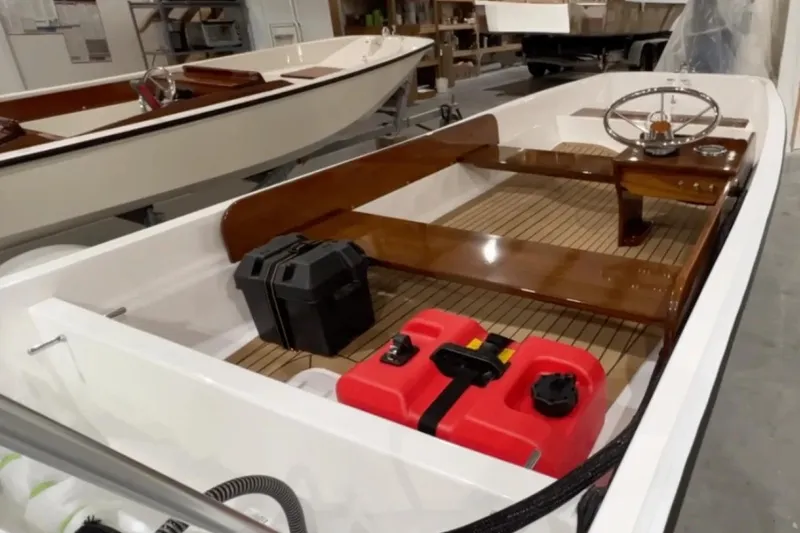 Slide: The Image of Manufacturer Provided Image: 2026 Metan Sport 13 boat interior with wooden accents and red fuel container. - 4