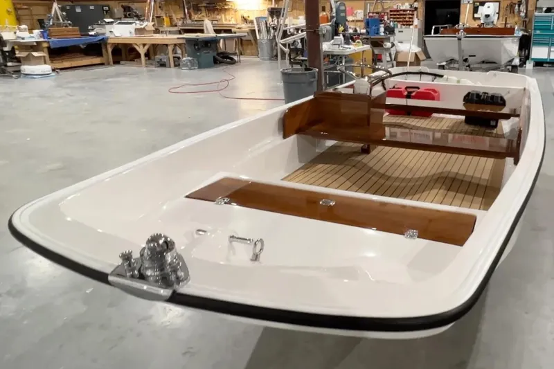 Slide: The Image of Manufacturer Provided Image: 2026 Metan Sport 13 boat in workshop, showcasing sleek design and wooden accents. - 5