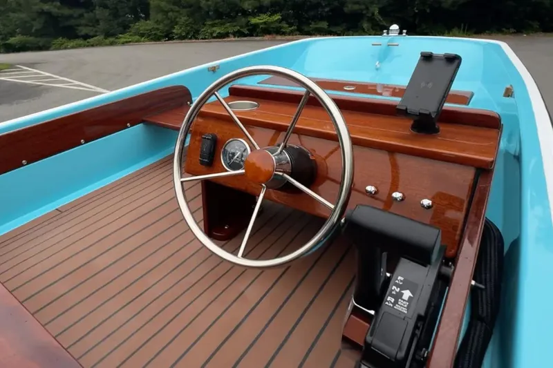 Slide: The Image of Manufacturer Provided Image: Interior of 2026 Metan Super Sport 13 boat with wooden dashboard and steering wheel. - 3