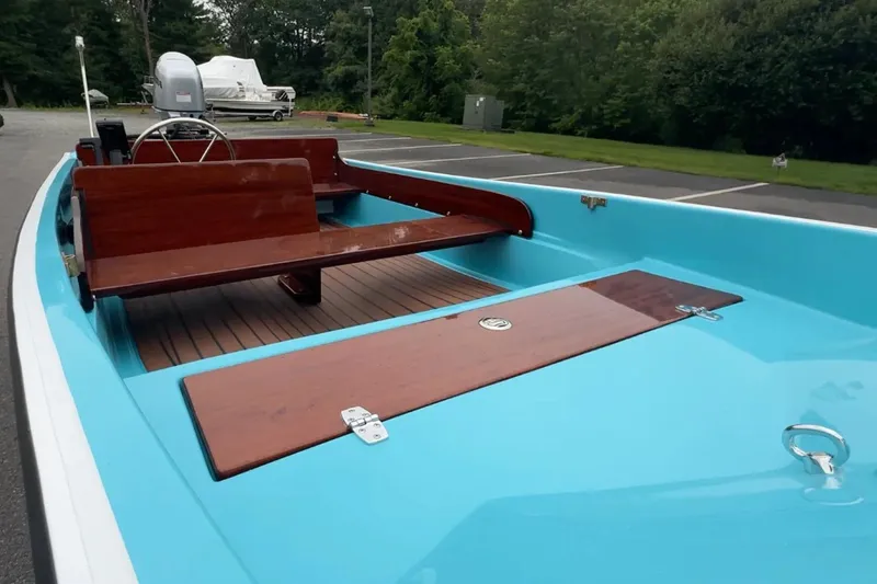 Slide: The Image of Manufacturer Provided Image: 2026 Metan Super Sport 13 boat with blue interior and wooden accents in a parking lot. - 4