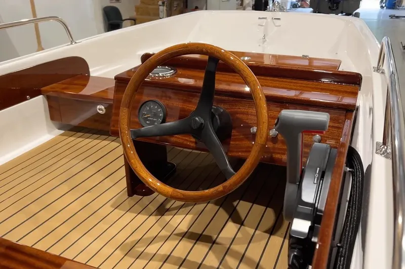 Slide: The Image of Manufacturer Provided Image: 2026 Metan Tender 13 boat interior with wooden steering wheel and dashboard. - 3