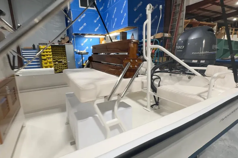 Slide: The Image of Manufacturer Provided Image: 2026 Metan Davenport 17 boat interior with seating and Yamaha engine in a workshop setting. - 3