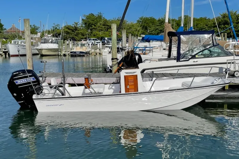 Slide: The Image of Manufacturer Provided Image: 2026 Metan Davenport 17 boat docked in a marina, featuring a sleek design and Mercury outboard motor. - 5