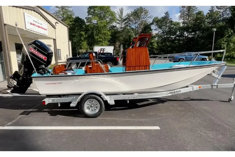 The Image of Manufacturer Provided Image: 2026 Metan Manhasset 17 boat on trailer, parked outdoors near a building. - 1